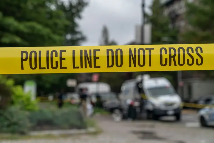 NYPD installs tape around crime scene on August 16th, 2020, near Prospect Park in Brooklyn where fatal shooting occurred.